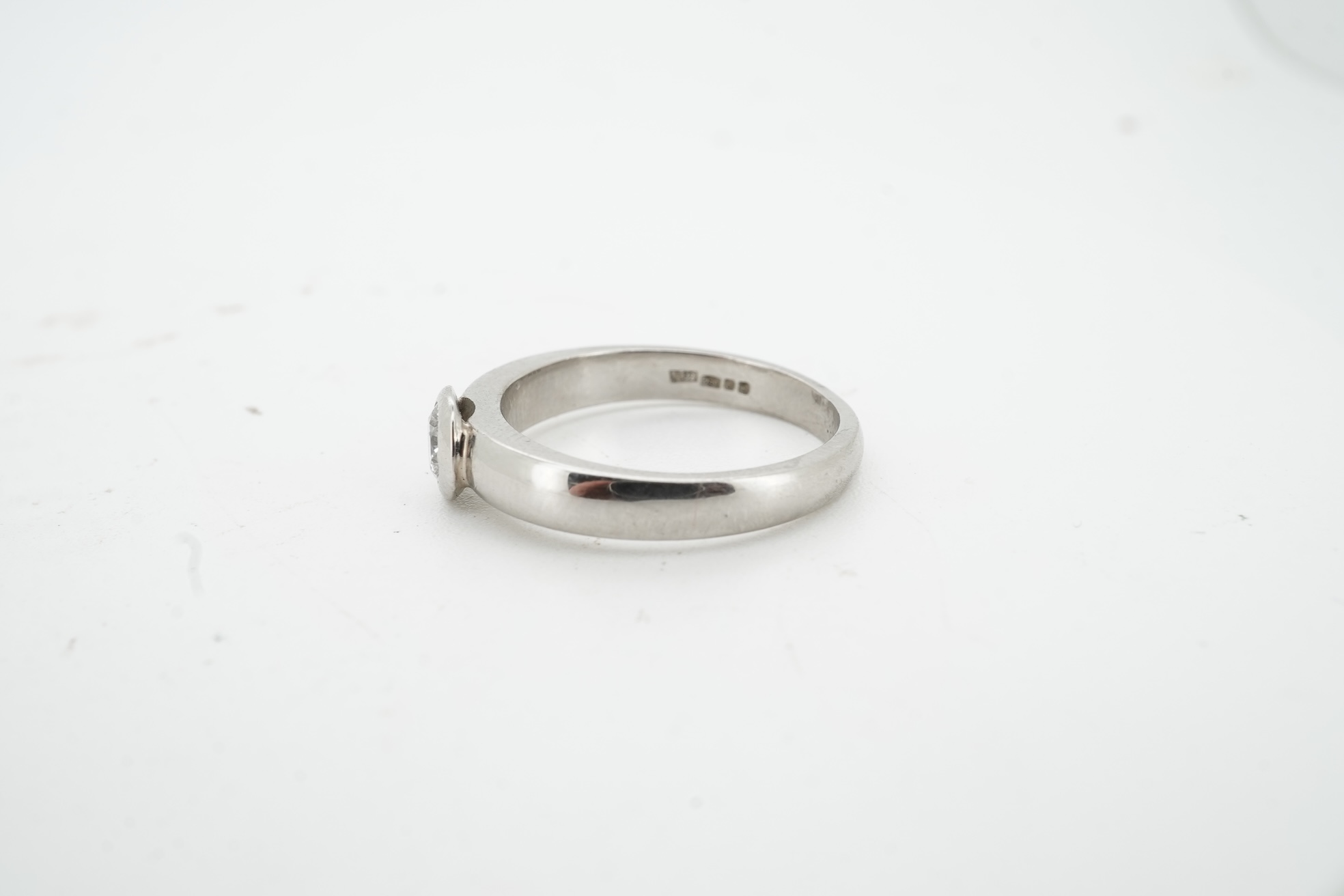 A diamond ring, collet-set with a brilliant-cut diamond weighing approximately 0.52 carats, mounted in platinum, size K1/2, British hallmarks, gross weight approximately 4 grams